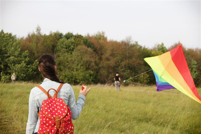 Woman and flying kite