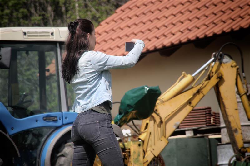 Woman documenting work on phone