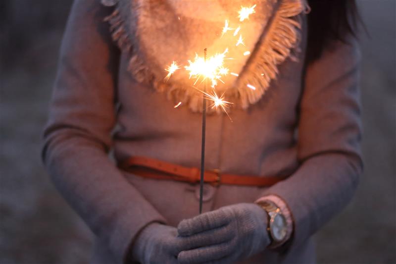 Woman holding a lit sparkler