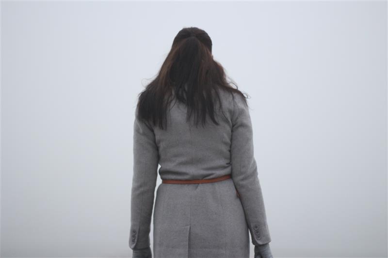 Woman looking into the fog
