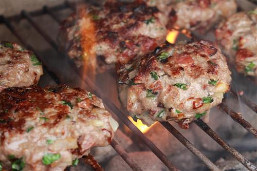 Grilling meat on the spit for homemade burgers