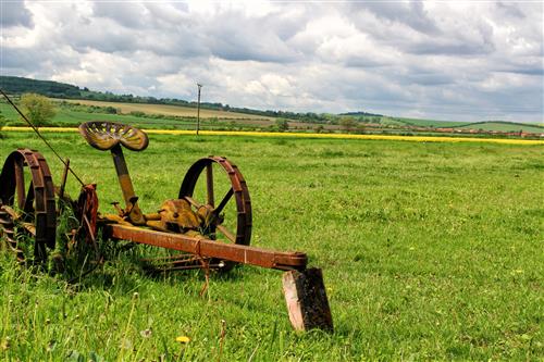Old agricultural machine on a meadow